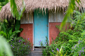 Fototapeta na wymiar Outside Toilet and thatched buildings 