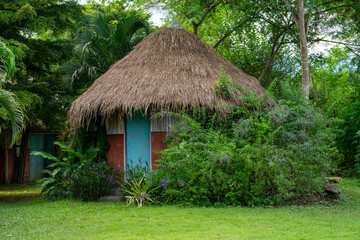 Fototapeta na wymiar Outside Toilet and thatched buildings 