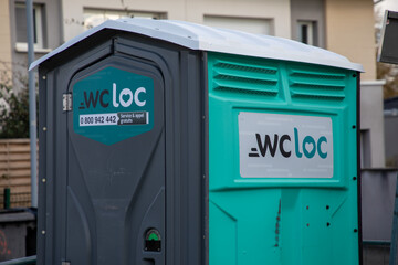 wcloc rental sign brand and text logo on green and grey porta potties rent for construction site