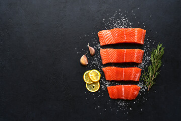 Raw fresh organic trout fillet with ingredients for cooking. Top view with copy space.