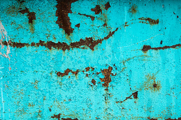 Turquoise paint on rusty metal