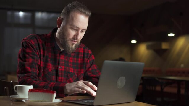 Successful Caucasian man freelancer work laptop in cafe. Freelance and remote work