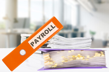 PAYROLL. Business office with office folders and stacks of papers on the desk.
