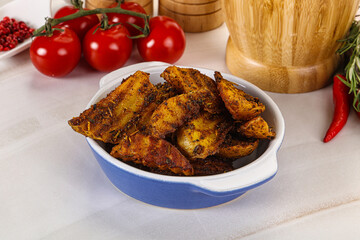 Golden baked potato Idaho with spices