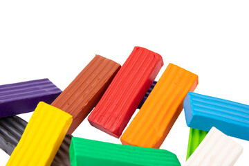 Multicolored plasticine, kids plasticine in the form of cubes and strips. White isolated background.