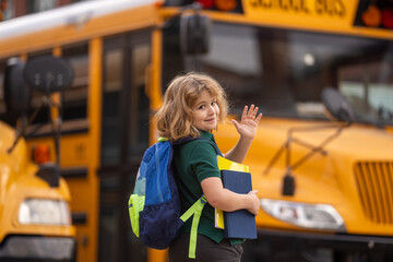 Pupil with backpack and book getting on the school bus. American School. Back to school. Bye bye. Kid of primary school. Happy children ready to study.