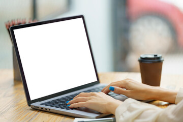 Close-up hand of businesswoman using a laptop.