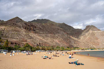 Fototapeta na wymiar Playa De Las Americas, Tenerife, Spain - 03.12.2023: People at Playa De Las Americas, Tenerife, Spain