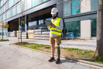 Engineer with prosthetic leg working on construction site