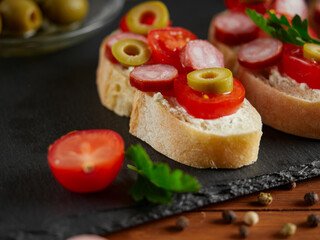 Bruschetta with tomatoes, mozzarella cheese and basil on a cutting board. Traditional italian appetizer or snack, antipasto. Top view with copy space. 