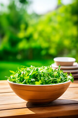 Arugula in a bowl against the backdrop of the garden. Selective focus.