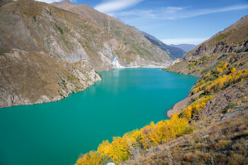 Tranquil Blue Reservoir Amidst the Serene Mountain Landscape with Lush Vegetation