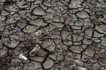 plastic polluted cracked earth background. Global warming, climate change and global warming concept. Environmental pollution
