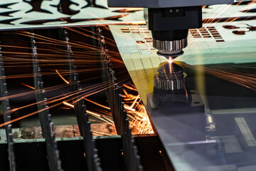 Fototapeta na wymiar The fiber laser cutting machine cut the metal plate with the sparkling light.