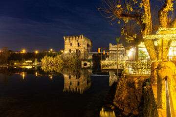 Enchanting Night: Reflective Elegance by the Tranquil Waters