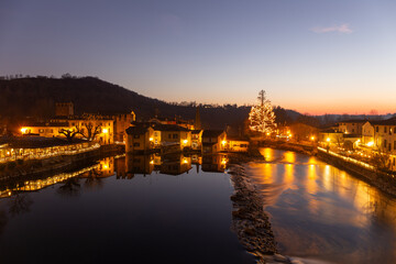Borghetto sul Mincio, Christmas 2023: A magical nocturnal scene with historic houses reflected in...