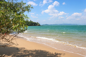 Sandy beach against the backdrop of the turquoise sea, tropical paradise, time for vacation and relaxation.