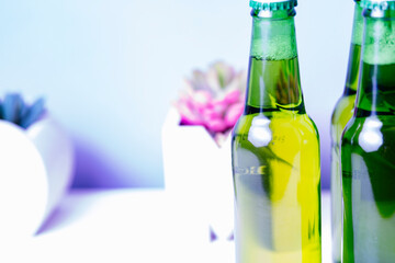A green bottle of beer with the background out of focus.