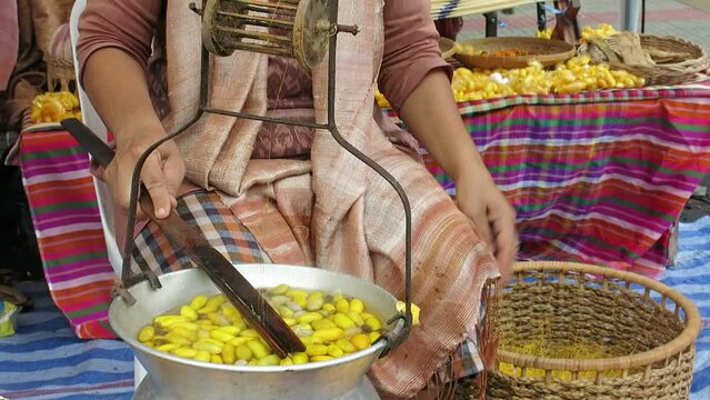 Traditionally making silk thread by boiling silkworm cocoons and spinning into the thread, Thailand