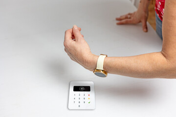 Paying with a watch at a payment terminal. Online shopping. Business, remote work, always connected, online banking concept