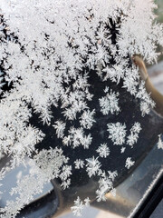 Snowflakes on the windshield of a car before Christmas