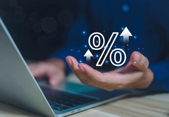 Businessman holding percentage sign in hand showing discount interest rate for commercial investment. To calculate business tax rates on a gray background.