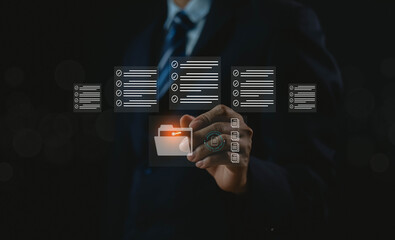 Business people use computers to upload documents from folders to manage online document databases and organize file space on a software system. To disseminate information in various agency offices