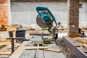 A cutting machine prepared for cutting wooden construction on building site.