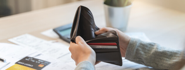 Close-up hand open empty wallet have a financial trouble to pay bills and loan.