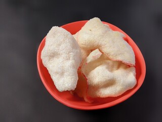 Cassava crackers after frying on a black background