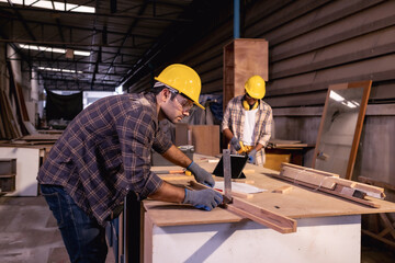 Fototapeta na wymiar Young White and blur American Affrican men carpenter labor, craftman working in wood workshop together, furniture industry.