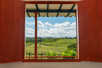 View of Colombia rural country with cows from cottage window - stock photo