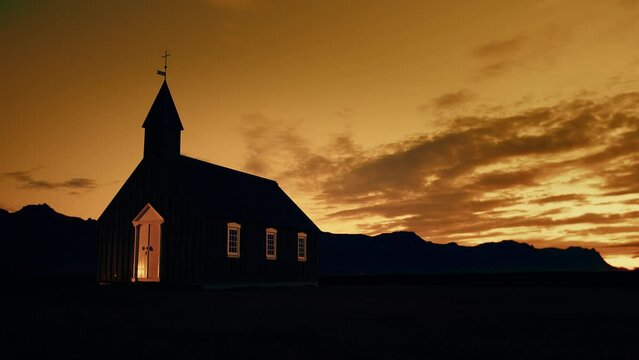 Black church, Budakirkja with amazing clouds in golden hour, Budir, Iceland