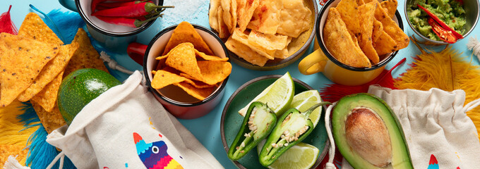 Cinco de mayo party food. Mexican holiday traditional dishes, snacks, tortilla corn chips, nachos, tacos, salsa, sauces.