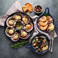 Fried scallops with butter and green sauce served in seashells.
