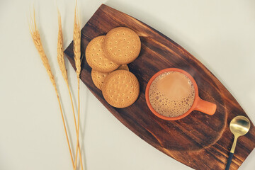 Herbal tea in Earthen cups known as Kulhad. Locally called Kulhad chai or cutting chai or masala chai or matka tea. Tea with Biscuit - obrazy, fototapety, plakaty