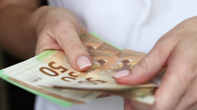 Woman counting Euro bills in hands, closeup view on various banknotes. Business crisis concept.