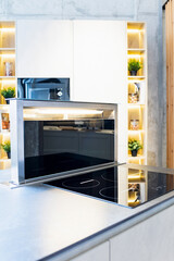 Vertical photo of a telescopic countertop extractor fan inside a studio kitchen in an exhibition...