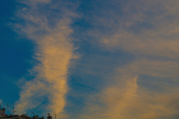 Foggy clouds in the sky create the effect of smoke, weather phenomena in nature. In windy weather