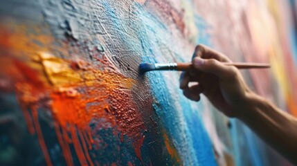 Close up of a person's hand holding a paintbrush. Can be used for creative projects or art-related themes