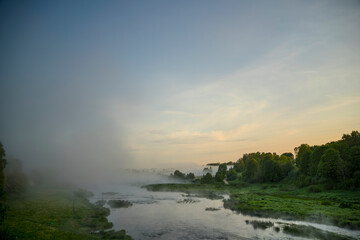 sunset over the river Venta in fog