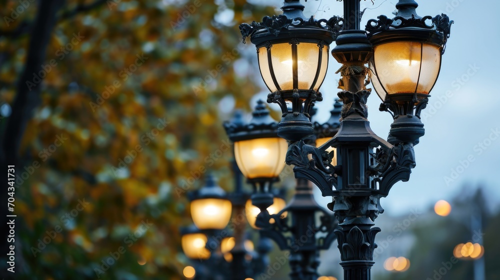 Poster a city street with a row of street lights. this picture can be used to depict urban environments or 