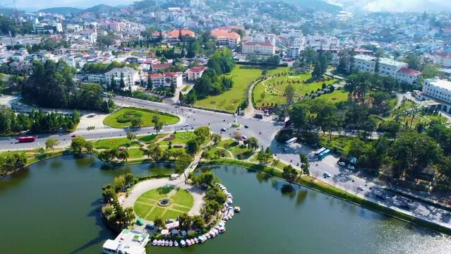 Aerial view of Da Lat City, Lam Dong Province. Drone flies straight towards Xuan Huong Lake.