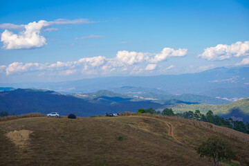 The beautiful natural scenery of happy recreation on the vacation of camp car style in the morning at Camp Car Camping site on the top of a mountain in winter season at Chiang Mai, Thailand.