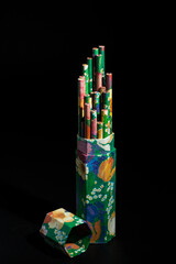 box with colorful paints with fantasy decoration, all on black background