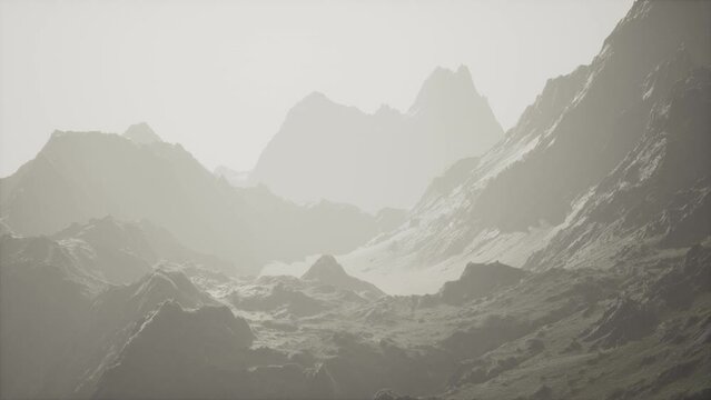 A view of a mountain range in the fog