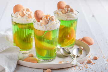 Sweet green jelly served with biscuits and sprinkles.