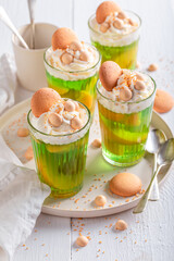 Homemade green jelly served with biscuits and sprinkles.