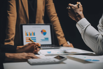 Financial analysts analyze business financial reports on a digital tablet planning investment project during a discussion at a meeting of corporate showing the results of their successful teamwork.