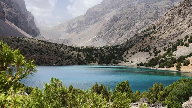 The Alaudin (Chapdara) lakes, lying at an altitude of 2800 m, are considered one of the most beautiful lakes of the Fan Mountains. Turquoise mountain lake. Pamiro-Alai. Tajikistan, Pamir 4K